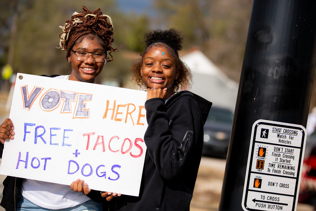 Girls holding a sign that says 