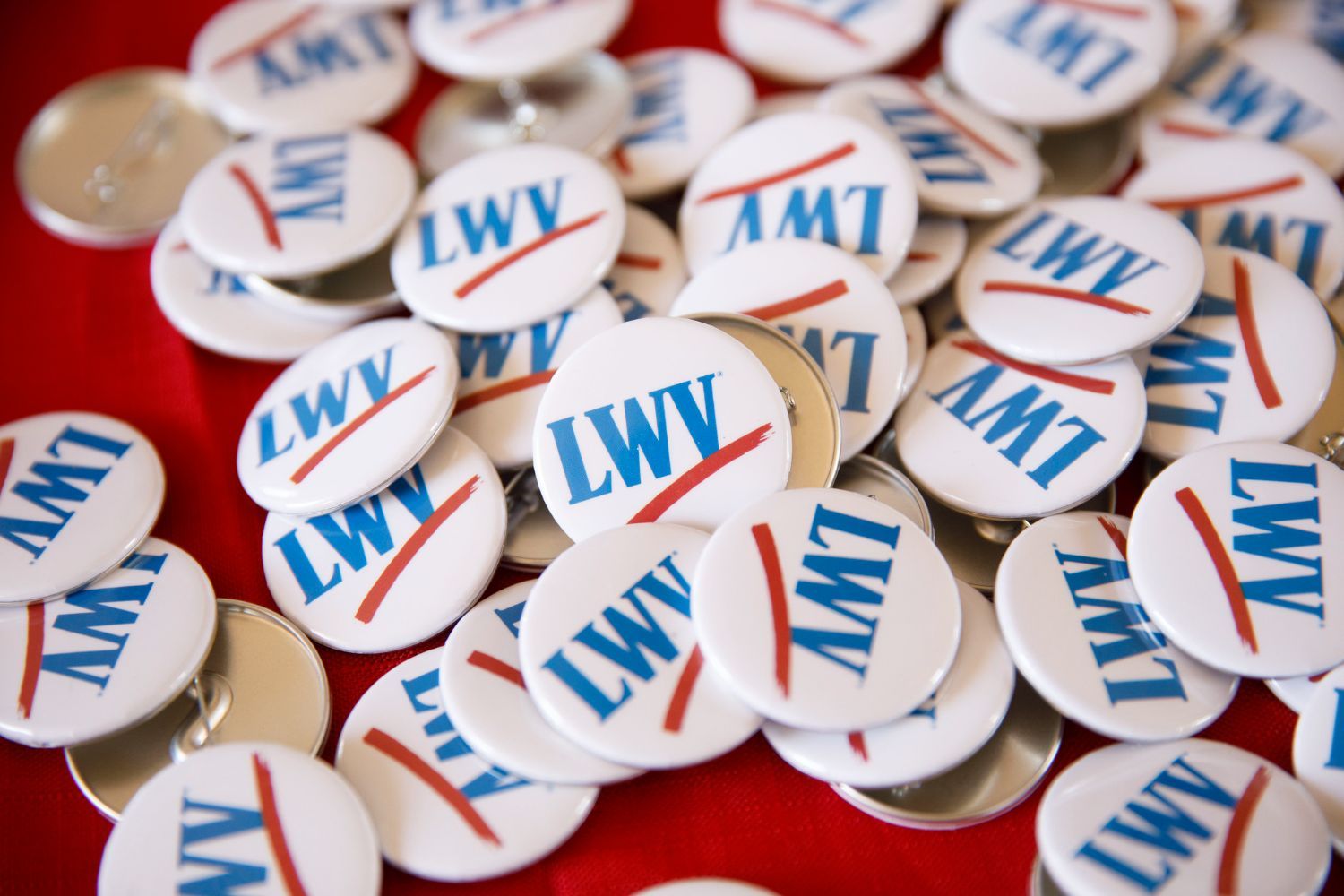 Pile of white buttons with red/blue LWV logo