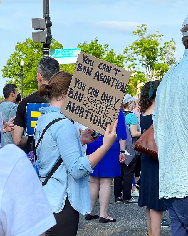 A protestor with a sign that says 